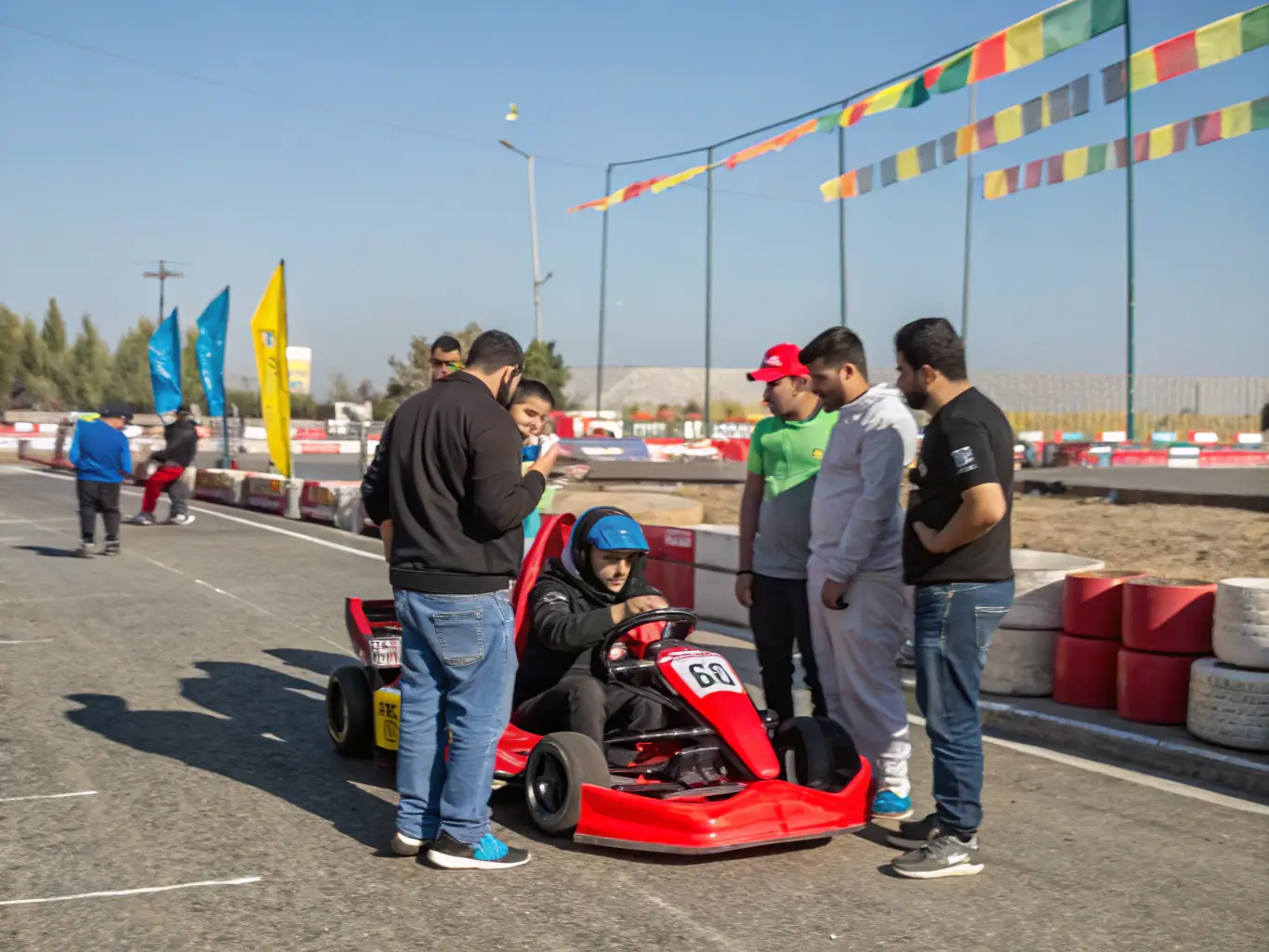 A photograph of community members participating in a karting event, highlighting the inclusive and engaging atmosphere of LES TOURISTES KARTING TEAM.