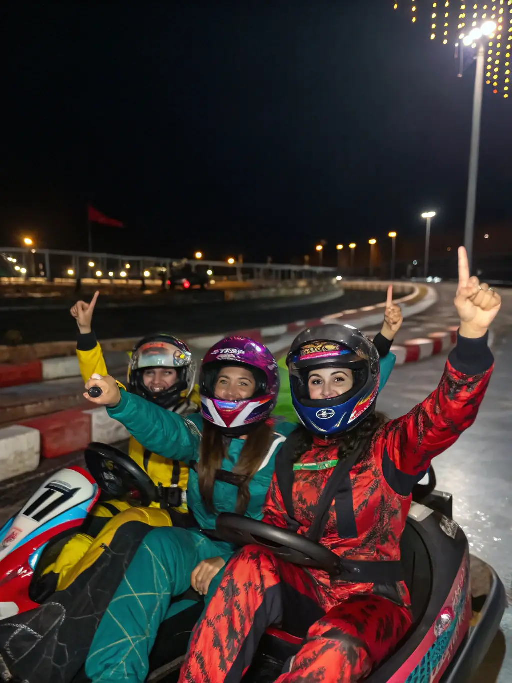 A diverse group of young karters celebrating a successful race, highlighting community engagement and youth development.